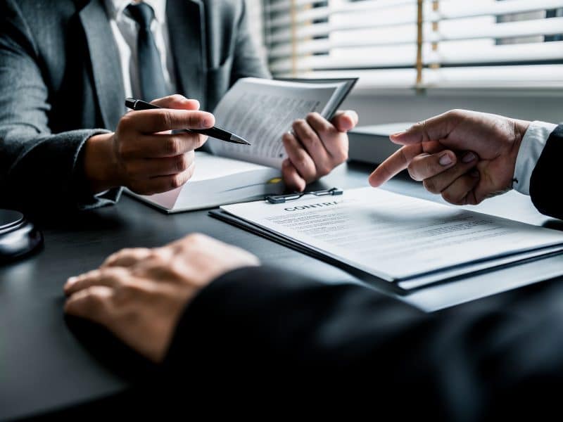 Close up of businessmen or lawyers discussing contract or busine